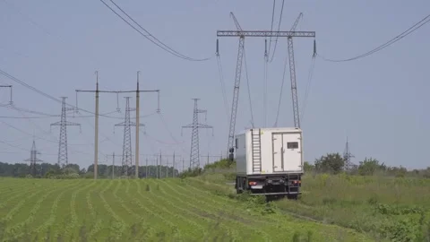 High-voltage electrical pylons  in the field Stock Footage 318549943