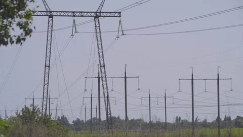 High-voltage electrical pylons  in the field Stock Footage 318549964