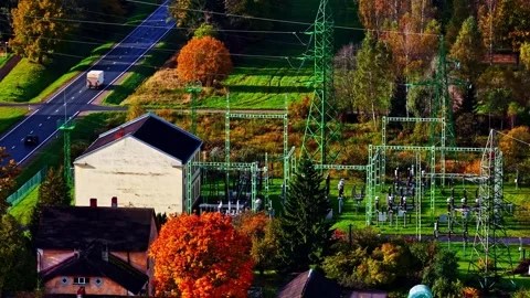 High-voltage electrical substation in semi-residential area with autumn trees Vídeo Stock 329144324