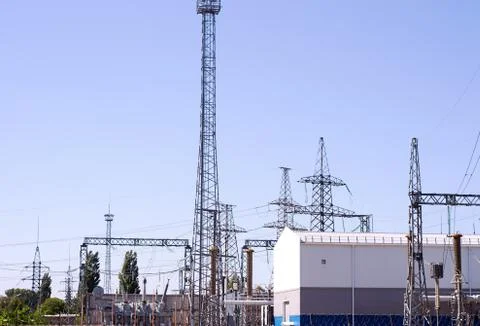 High voltage electrical substation with transformers and electric towers Stock Photos