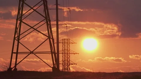 High-voltage electrical support, amazing orange sunset and the car goes on the r Stock Footage 105534170
