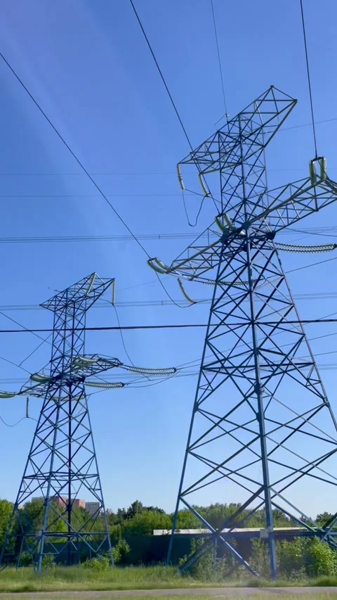 High voltage electrical tower with power transmission lines against blue sky. Stock Footage 339432205