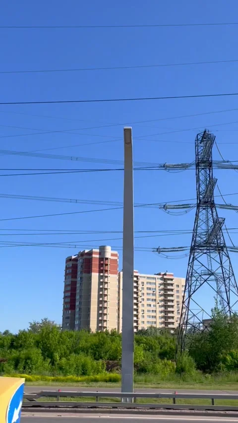 High voltage electrical tower with power transmission lines over residential Stock Footage 339434020