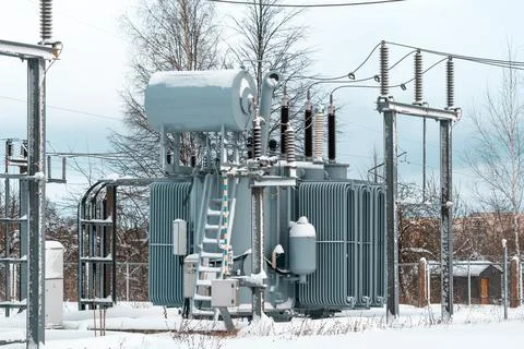 High voltage electrical transformer at a power plant in winter Stock Photos