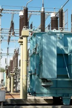 High voltage electrical transformers at a power station. Stock Photos