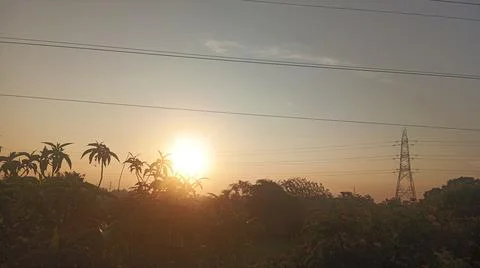 High-voltage electrical transmission tower during twilight or sunset 写真素材