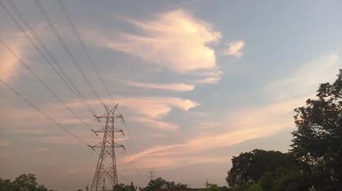High-voltage electrical transmission tower during twilight or sunset 写真素材