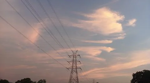 High-voltage electrical transmission tower during twilight or sunset 写真素材