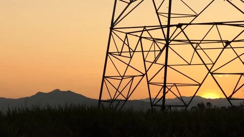 High voltage electricity tower and power lines at sunset above Stock Footage 82431830