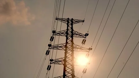 High Voltage Electricity Transmission Tower Against A Glowing Sunset Sky Video stock 342004336