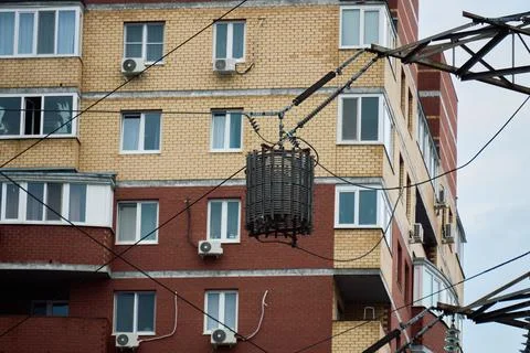 High Voltage Line Trap Mounted Near Apartment Building Stock Photos