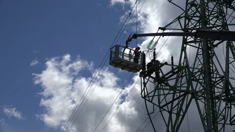 High Voltage Line Workers doing their job Stock Footage 239604872