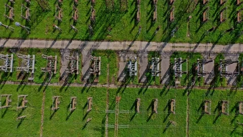 High voltage lines on green field. Power transmission lines. Stock Footage 134783786