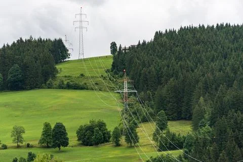 High voltage overhead power line, power pylon, steel lattice tower on hill Stock Photos