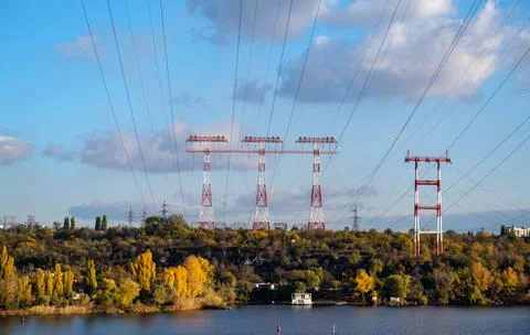 High voltage pillar, overhead power line, industrial background. power lines on Stock Photos