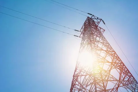 High voltage pole on blue sky background. High voltage tower. Stock Photos