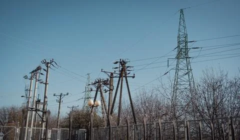High voltage pole - electrical infrastructure, electric pole and energy tower Stock Photos
