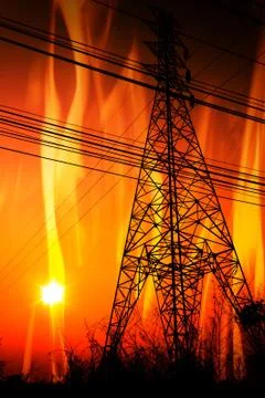 High voltage pole with a flame burning sunset Stock Photos