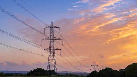 High voltage pole on silhouette sunset background Stockfoto's