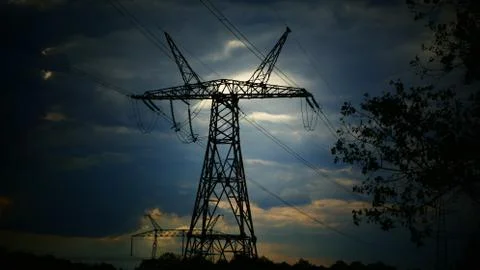 High-voltage poles on a background of a cloudy sunset. The power of energy. P Stock Photos