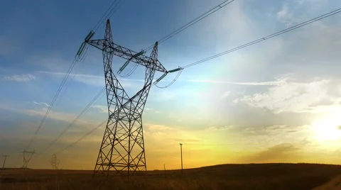 High voltage post and power lines at sunset Stock Footage
