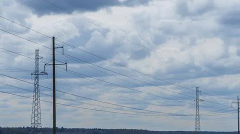 High voltage post on blue sky with clouds background. Electrical net of poles Stock Photos