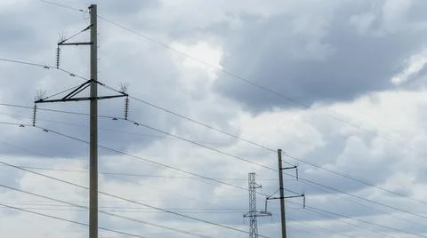 High voltage post on blue sky with clouds background. Electrical net of poles Stock Photos