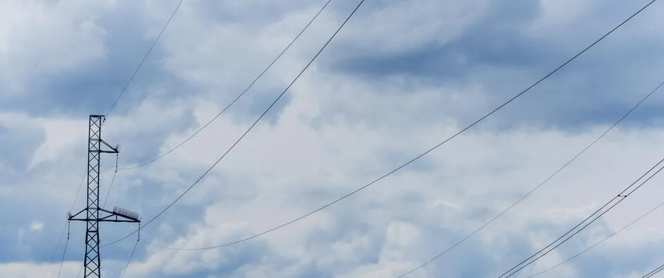 High voltage post on blue sky with clouds background. Electrical net of poles Stock Photos