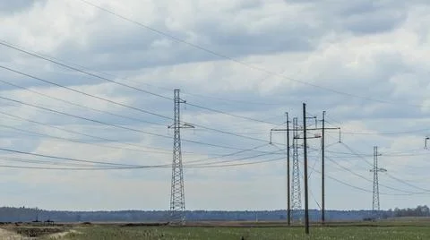 High voltage post on blue sky with clouds background. Electrical net of poles Stock Photos