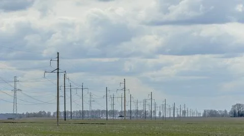 High voltage post on blue sky with clouds background. Electrical net of poles Stock Photos