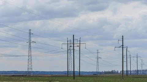 High voltage post on blue sky with clouds background. Electrical net of poles Stock Photos