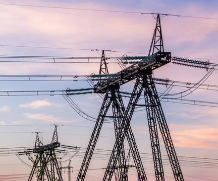 High voltage post. High-voltage tower with sunset and sky background. Stock Photos