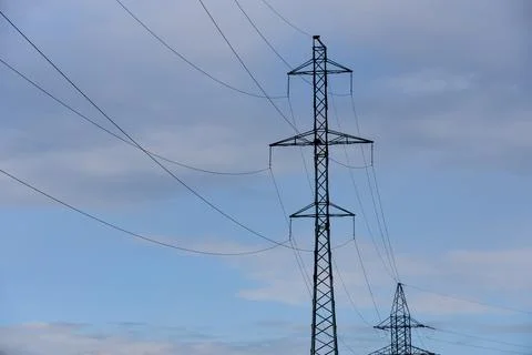 High voltage post. High-voltage tower blue cloudy sky background Stock Photos