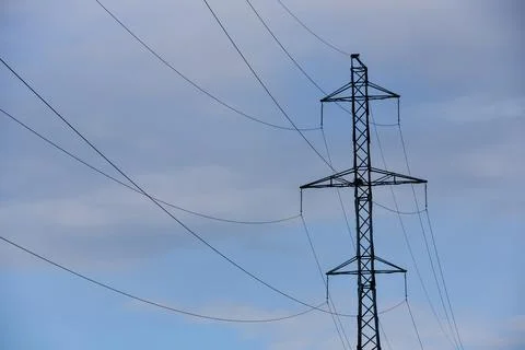 High voltage post. High-voltage tower blue cloudy sky background Stock Photos