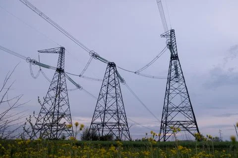 High voltage post or High voltage tower in the field. High voltage towers with Stock Photos