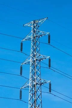 High voltage post or power transmission line tower and blue sky Stock Photos