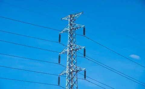 High voltage post or power transmission line tower and blue sky Stock Photos