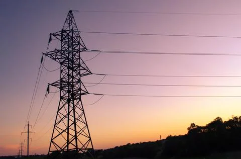 High voltage post at sunset. High-voltage tower sky background. Space for tex Stock Photos
