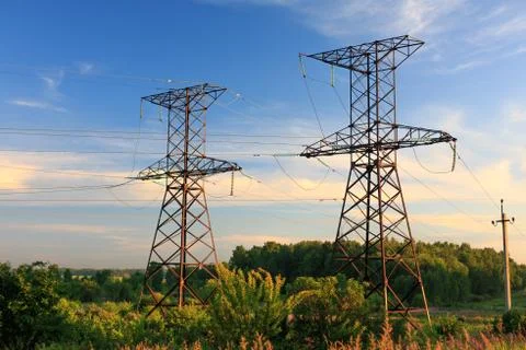 High voltage post at sunset. Stock Photos