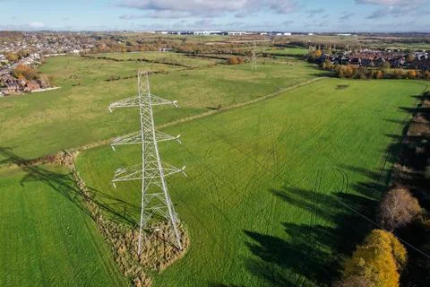 High voltage post,High voltage tower sky field grass housing esate aerial dro Stock Photos