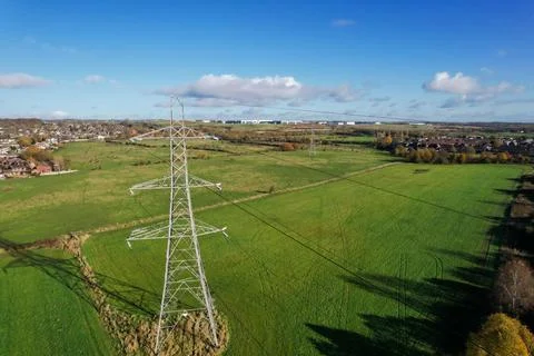 High voltage post,High voltage tower sky field grass housing esate aerial dro Stock Photos