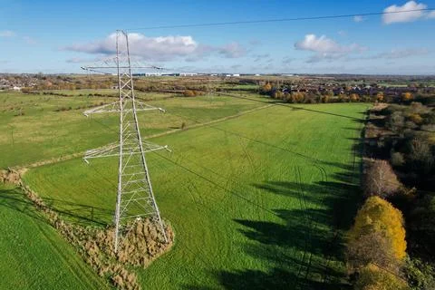 High voltage post,High voltage tower sky field grass housing esate aerial dro Stock Photos