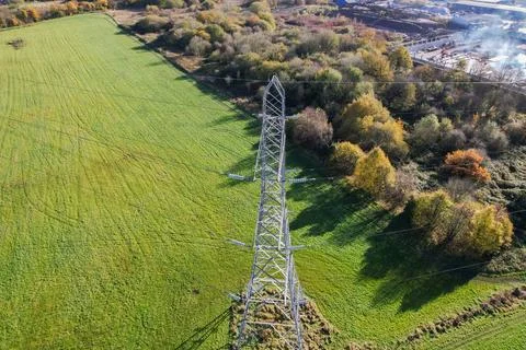 High voltage post,High voltage tower sky field grass housing esate aerial dro Stock Photos