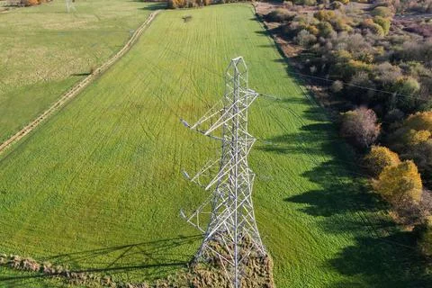 High voltage post,High voltage tower sky field grass housing esate aerial dro Stock Photos