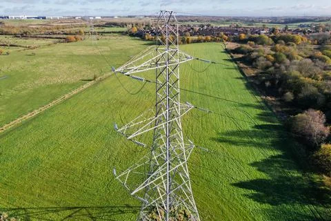 High voltage post,High voltage tower sky field grass housing esate aerial dro Stock Photos