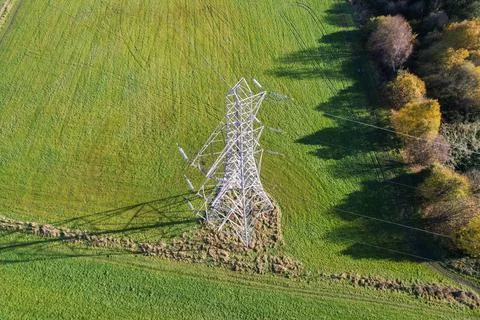 High voltage post,High voltage tower sky field grass housing esate aerial dro Stock Photos