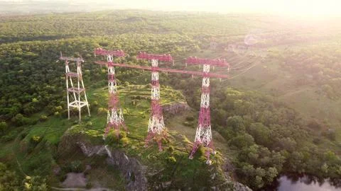 High voltage post.High-voltage tower sun beam. High voltage power lines on ro Фото