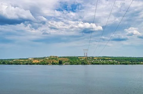High-voltage power line across the river Stock Photos