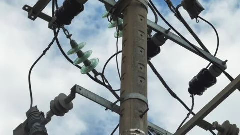 High Voltage Power Line Cross Arm with Glass Disc Insulators Against Sky Stock Footage 343331304