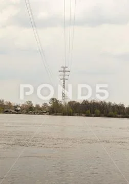 High-voltage power line over the river Stock Photos